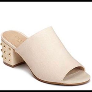 Cream open-toe mule with gold stud heel